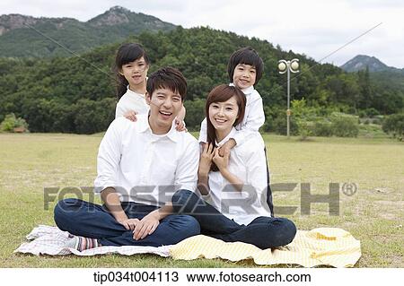 family wearing jeans posing at camera in picnic View Large Photo Image Stock Image - family wearing jeans posing at camera in picnic. Fotosearch