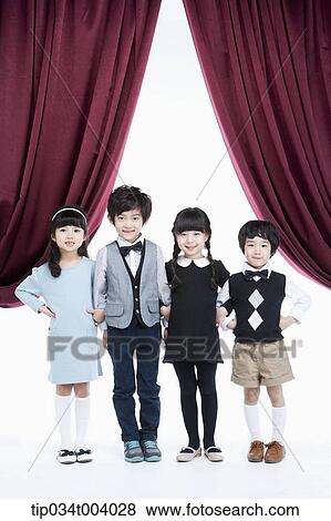 four kids on a stage with arms in arms View Large Photo Image Stock Photo - four kids on a stage with arms in arms . Fotosearch