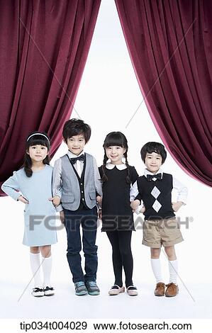 four kids on a stage with arms in arms View Large Photo Image Stock Photo - four kids on a stage with arms in arms . Fotosearch