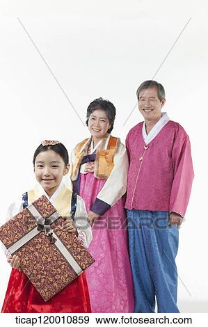 grandparents behind a girl holding present View Large Photo Image Stock Photo - grandparents behind a girl holding present . Fotosearch