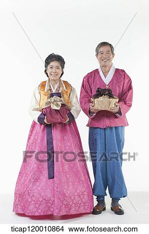 grandparents holding packages in Hanbok View Large Photo Image Picture - grandparents holding packages in Hanbok. Fotosearch