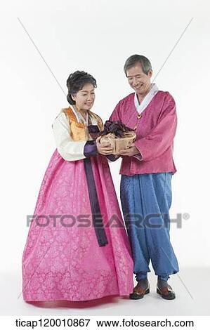 grandparents holding packages together in Hanbok View Large Photo Image Stock Photo - grandparents holding packages together in Hanbok. Fotosearch