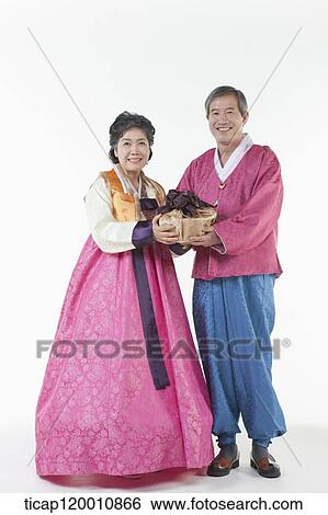 grandparents holding packages together in Hanbok View Large Photo Image Stock Photograph - grandparents holding packages together in Hanbok. Fotosearch