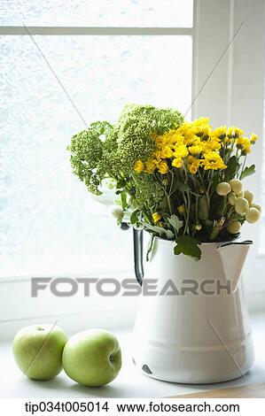 green apples next to a flower vase View Large Photo Image Picture - green apples next to a flower vase. Fotosearch