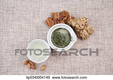 green powder and water in each cup with nuts on the floor View Large Photo Image Stock Photo - green powder and water in each cup with nuts on the floor . Fotosearch