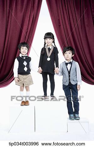 kids standing on podium in front of red curtains View Large Photo Image Stock Photograph - kids standing on podium in front of red curtains. Fotosearch