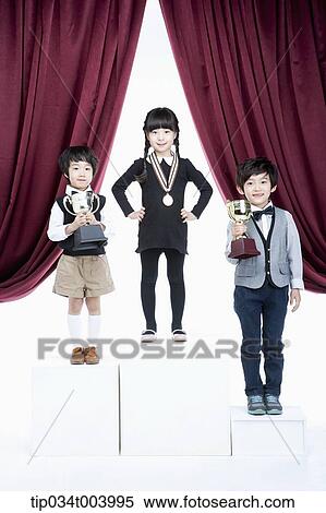 kids standing on podium in front of red curtains View Large Photo Image Stock Photography - kids standing on podium in front of red curtains. Fotosearch