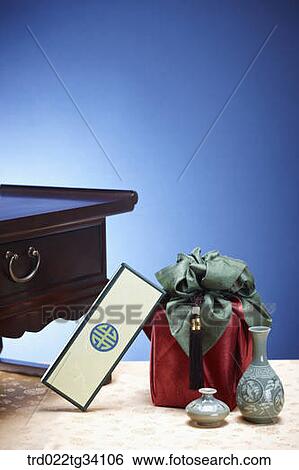 Stock Photograph - Korean box leaning on a package in Korean traditional wrap . Fotosearch