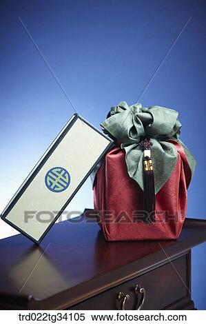 Stock Photography - Korean box leaning on a package in Korean traditional wrap . Fotosearch