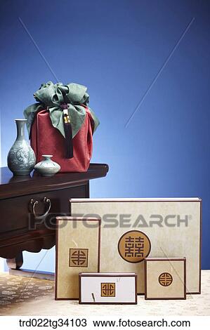 Stock Image - Korean boxes and a package in Korean traditional wrap with ceramics on a table. Fotosearch