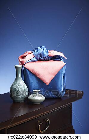 Stock Photo - Korean ceramics and a package in Korean traditional wrap on a table. Fotosearch