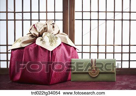 Picture - Korean traditional envelope and a package in front of Korean traditional paper door. Fotosearch