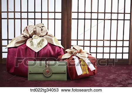 Stock Image - Korean traditional envelope and packages in front of Korean traditional paper door. Fotosearch