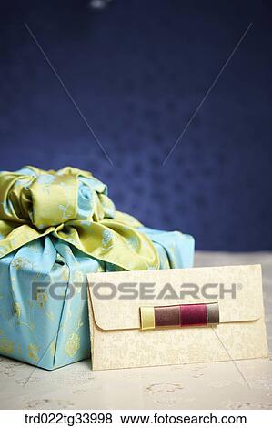 Stock Photo - Korean traditional envelope next to a package wrapped in traditional wrap . Fotosearch