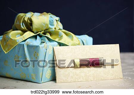 Stock Photo - Korean traditional envelope next to a package wrapped in traditional wrap . Fotosearch