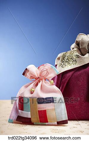 Korean traditional luck pocket in front of a package in a red Korean traditional wrap View Large Photo Image Stock Photograph - Korean traditional luck pocket in front of a package in a red Korean traditional wrap . Fotosearch