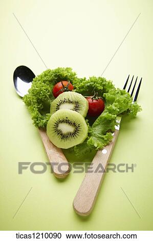 lettuce with fruits between spoon and a fork View Large Photo Image Stock Image - lettuce with fruits between spoon and a fork. Fotosearch