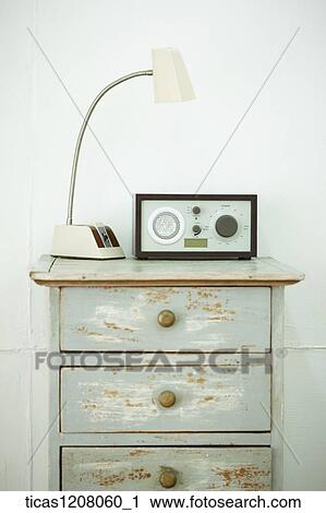 Stock Image - light stand and radio on the drawer. Fotosearch