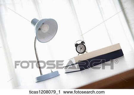 light stand, books, and a clock on the table View Large Photo Image Stock Image - light stand, books, and a clock on the table . Fotosearch