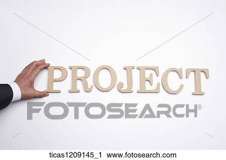 Stock Image - man putting a letter of P to make up of PROJECT. Fotosearch
