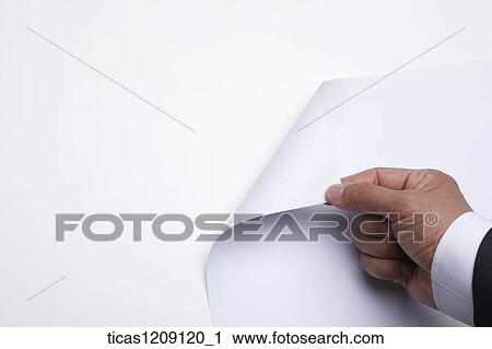 Stock Image - man turning over the paper. Fotosearch
