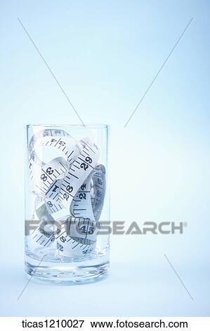 measurement tape in a glass cup View Large Photo Image Stock Photo - measurement tape in a glass cup. Fotosearch