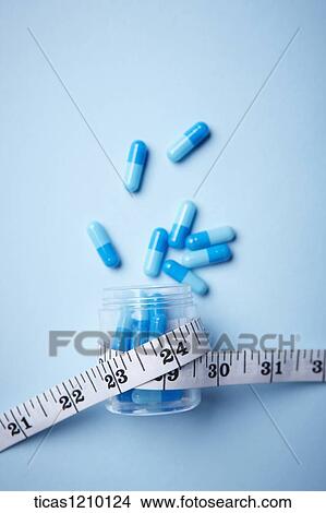 measurement tape surrounding a capsule case View Large Photo Image Picture - measurement tape surrounding a capsule case. Fotosearch
