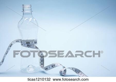 measurement tape surrounding an empty bottle View Large Photo Image Stock Image - measurement tape surrounding an empty bottle. Fotosearch