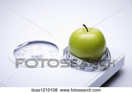 measurement tape surrounding apple on a weight scale View Large Photo Image Stock Photo - measurement tape surrounding apple on a weight scale. Fotosearch