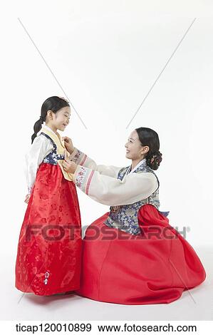 mother fixing daughter's Hanbok View Large Photo Image Stock Photo - mother fixing daughter's Hanbok. Fotosearch