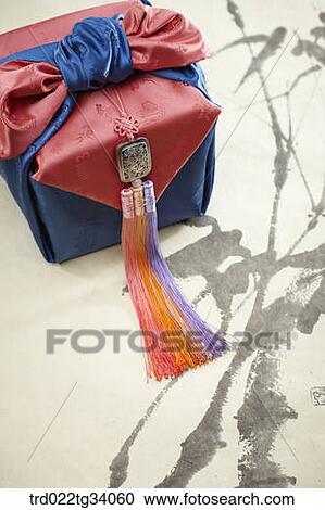 Stock Image - norigae and Korean traditional package on Korean traditional paper. Fotosearch