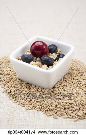 nuts, blueberries and a cheery in a small bowl with seeds under a bowl View Large Photo Image Picture - nuts, blueberries and a cheery in a small bowl with seeds under a bowl . Fotosearch