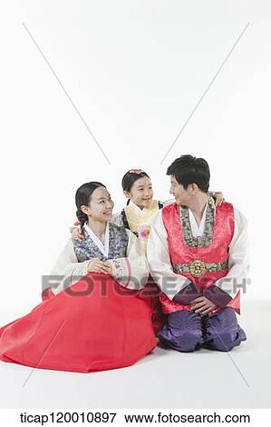 Stock Photo - parents and a daughter in Hanbok posing together . Fotosearch