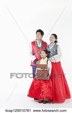 parents in Hanbok standing behind a daughter holding a present View Large Photo Image Stock Image - parents in Hanbok standing behind a daughter holding a present . Fotosearch
