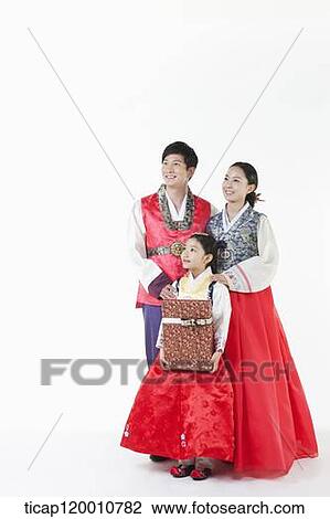 parents in Hanbok standing behind a daughter holding a present View Large Photo Image Stock Image - parents in Hanbok standing behind a daughter holding a present . Fotosearch