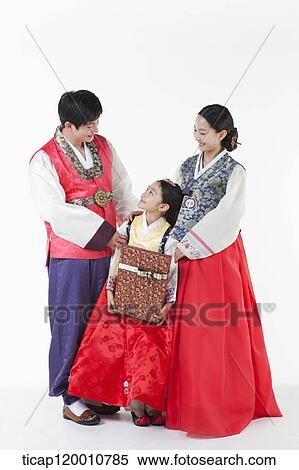 parents in Hanbok standing behind a daughter holding a present View Large Photo Image Stock Photography - parents in Hanbok standing behind a daughter holding a present . Fotosearch