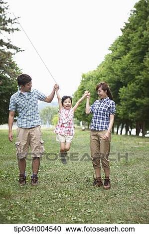 parents lifting a daughter up View Large Photo Image Stock Image - parents lifting a daughter up . Fotosearch