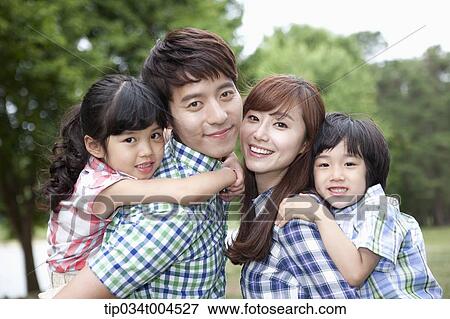 Stock Photo - parents posing with kids in their back . Fotosearch