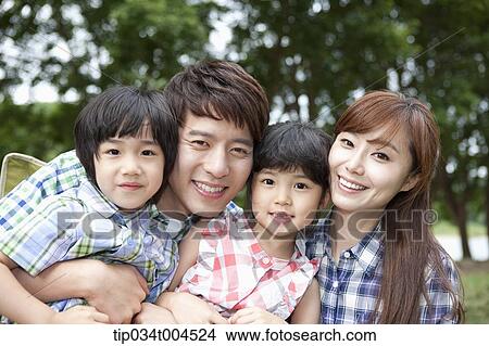 Picture - parents with kids posing . Fotosearch
