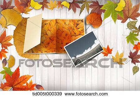 pictures of autumn atmosphere on a wooden plank surrounded by autumn leaves View Large Photo Image Stock Photo - pictures of autumn atmosphere on a wooden plank surrounded by autumn leaves. Fotosearch