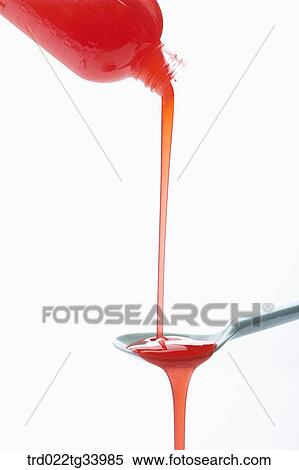 pouring red syrup in a spoon View Large Photo Image Stock Photography - pouring red syrup in a spoon. Fotosearch