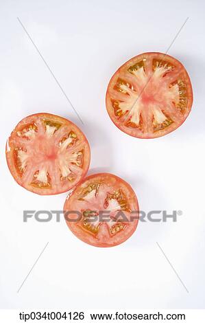 Stock Photograph - red tomatoes with some of tomatoes cut in half. Fotosearch