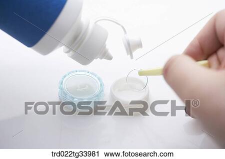 Stock Image - sanitizing contact lens . Fotosearch