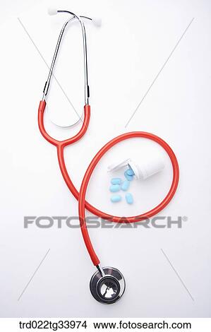 stethoscope and blue medicine tablets from a drug bottle View Large Photo Image Picture - stethoscope and blue medicine tablets from a drug bottle . Fotosearch
