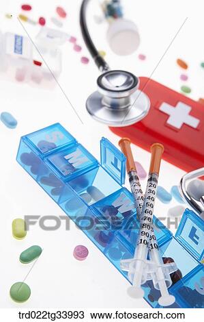 Stock Image - stethoscope and colourful pills all over. Fotosearch
