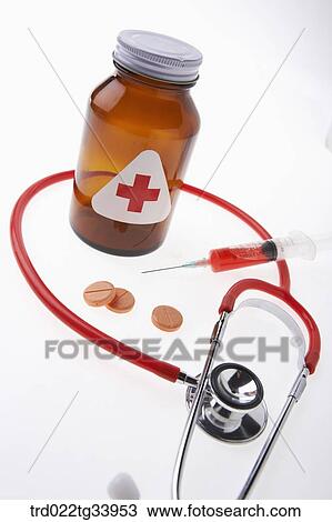 Stock Image - stethoscope with other medicine and injection needle . Fotosearch