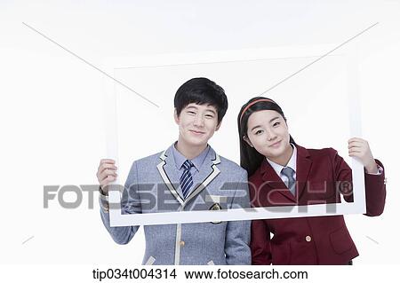 students with school uniform posing inside a white frame they are holding View Large Photo Image Picture - students with school uniform posing inside a white frame they are holding . Fotosearch