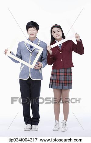 Stock Photo - students with school uniform posing inside each white frame they are holding . Fotosearch