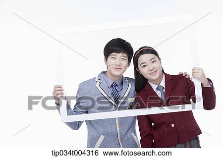 students with school uniform posing inside a white frame they are holding View Large Photo Image Stock Photograph - students with school uniform posing inside a white frame they are holding . Fotosearch