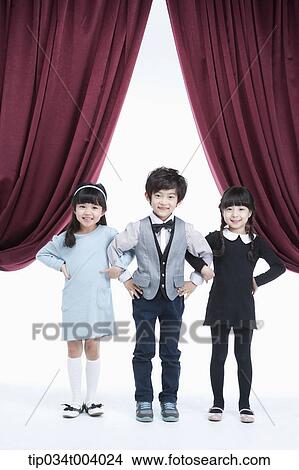 three kids on a stage arms in arms View Large Photo Image Picture - three kids on a stage arms in arms . Fotosearch